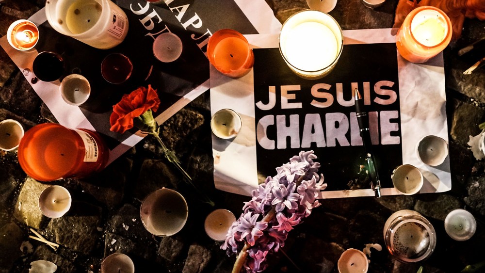 Papers with 'I am Charlie' displayed are left near candles at a vigil in front of the French Embassy following the terrorist attack in Paris on January 7, 2015 in Berlin, Germany. (Photo by Carsten Koall/Getty)