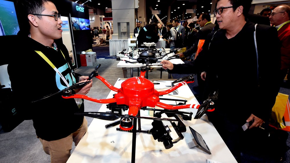 Guanglong Zeng, of EHang Inc., shows attendees the Skyway drone by EHang at the 2015 International CES at the Las Vegas Convention Center on Jan. 8, 2015 in Las Vegas, Nev. (Photo by Ethan Miller/Getty)