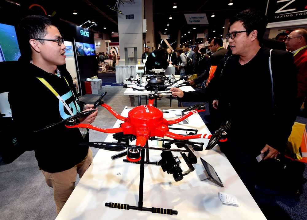 Guanglong Zeng, of EHang Inc., shows attendees the Skyway drone by EHang at the 2015 International CES at the Las Vegas Convention Center on Jan. 8, 2015 in Las Vegas, Nev. (Photo by Ethan Miller/Getty)