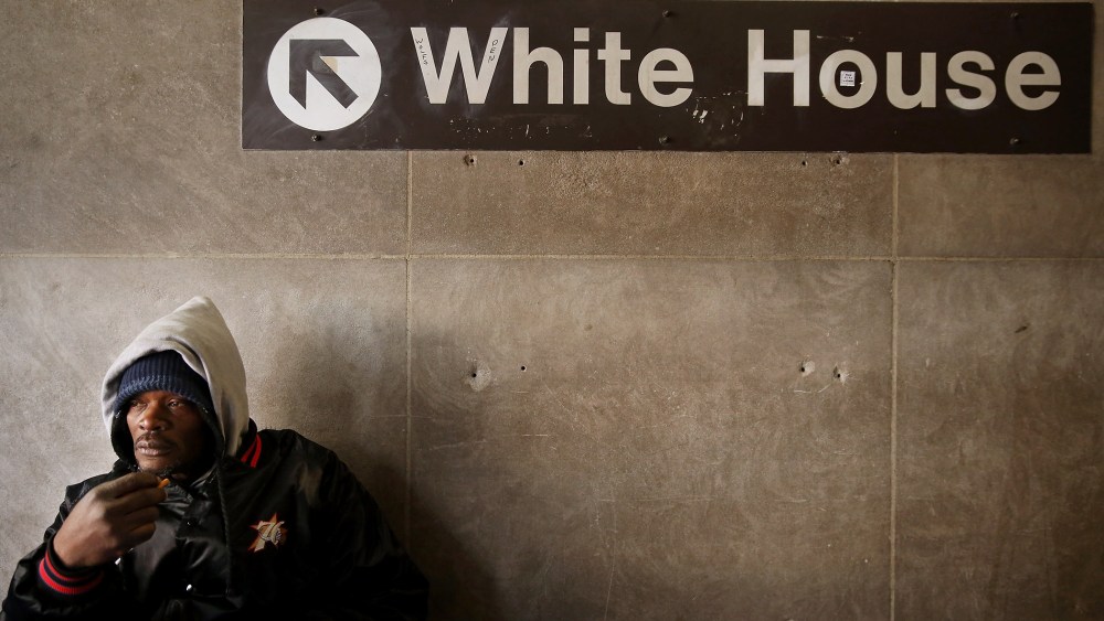 A homeless man steels himself against single-digit temperatures in the McPhearson Square Metro station in Washington, Jan. 7, 2014.
