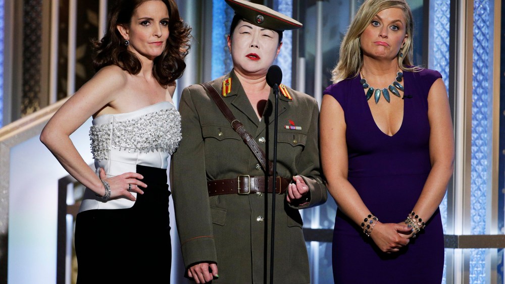 In this handout photo provided by NBCUniversal, Tina Fey, Margaret Cho and Amy Poehler speak onstage during the 72nd Annual Golden Globe Awards on Jan. 11, 2015 in Beverly Hills, Calif. (Photo by Paul Drinkwater/NBCUniversal/Getty)