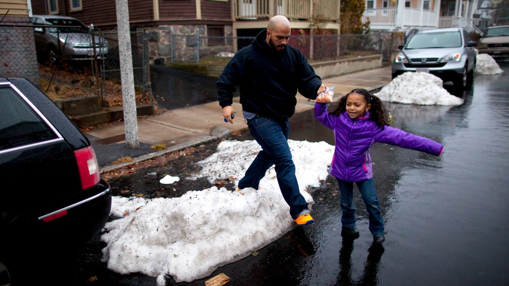 Yasmani Santiago, 32, of Dorchester, walks his daughter to the car, Dec. 23, 2013. Santiago is one of the tens of thousands of Massachusetts residents who prepared to lose their unemployment benefits on Dec. 28th.