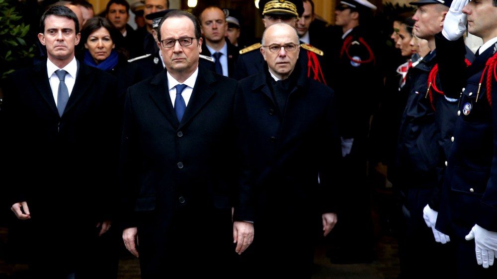 French President Francois Hollande (C), Prime Minister Manuel Valls (L) and Interior Minister Bernard Cazeneuve (R) pay tribute to the three police officers killed in the islamist attacks on Jan. 13, 2015 in Paris. (Photo by Francois Mori/AFP/Getty)