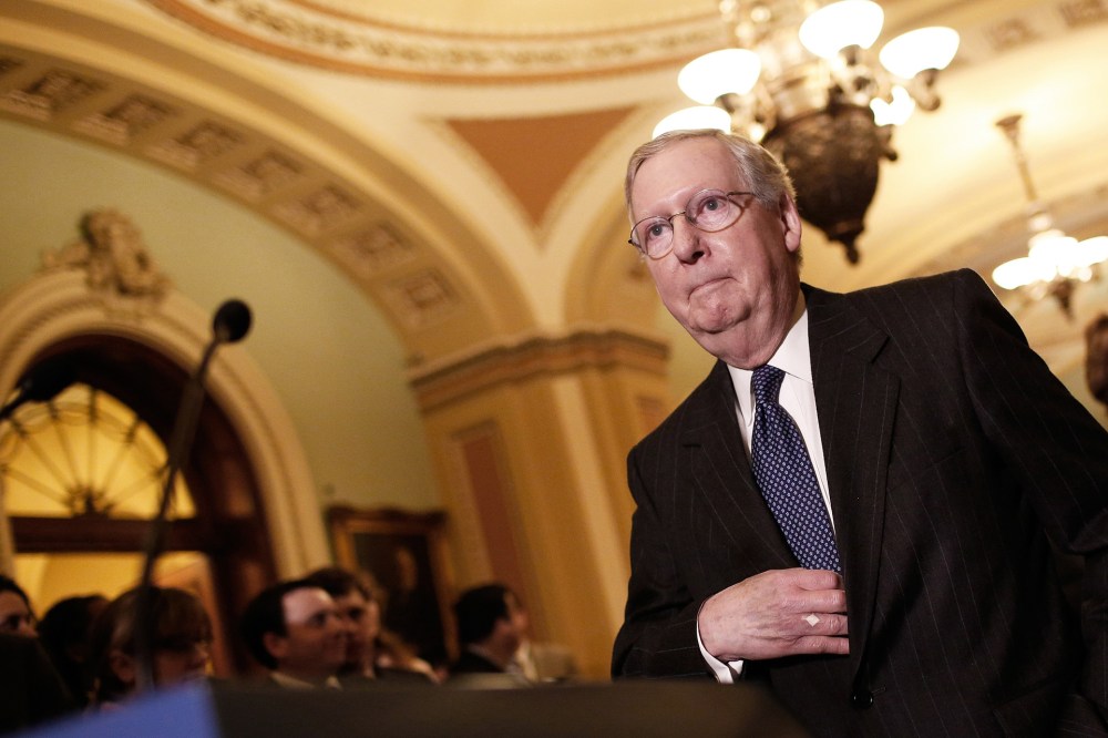 Senate Majority Leader Mitch McConnell (R-KY) arrives to take questions from members of the press following a weekly policy luncheon with Senate Republicans at the U.S. Capitol on Jan. 13, 2015 in Washington, D.C. (Photo by Win McNamee/Getty)