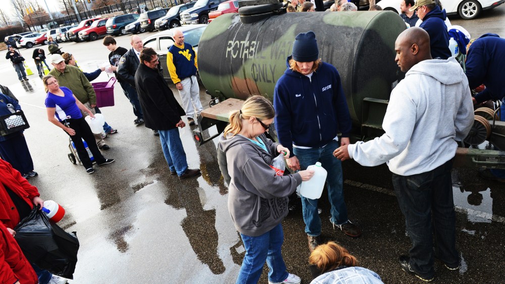 West Virginia American Water customers line up for water at the Gestamp Plant in South Charleston, West Virginia, Jan. 10, 2014.