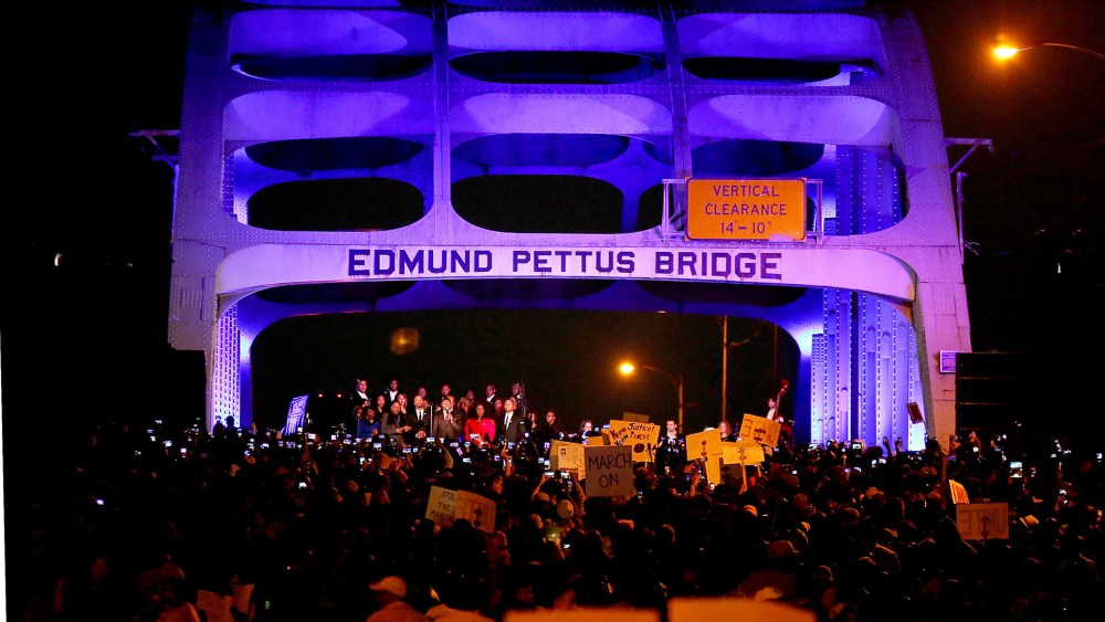 Thousands march across the Edmund Pettus Bridge along with members of the cast of the movie "Selma" in honor of Rev. Martin Luther King Jr. Day on Jan. 18, 2015 in Selma, Alabama. (Photo by Sean Gardner/Getty)