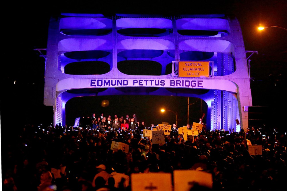 Thousands march across the Edmund Pettus Bridge along with members of the cast of the movie "Selma" in honor of Rev. Martin Luther King Jr. Day on Jan. 18, 2015 in Selma, Alabama. (Photo by Sean Gardner/Getty)