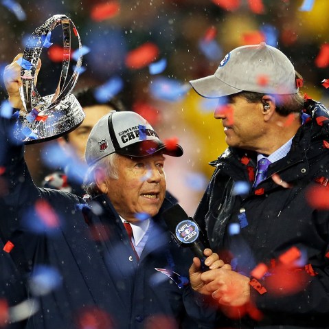 New England Patriots owner Robert Kraft holds up the Lamar Hunt Trophy after defeating the Indianapolis Colts in the 2015 AFC Championship Game at Gillette Stadium on Jan. 18, 2015 in Foxboro, Mass. (Photo by Jim Rogash/Getty)