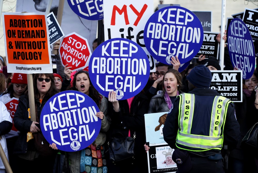 Pro-choice activists shout slogans before the annual March for Life passes by the U.S. Supreme Court, Jan. 22, 2015 in Washington, DC. (Photo by Alex Wong/Getty)