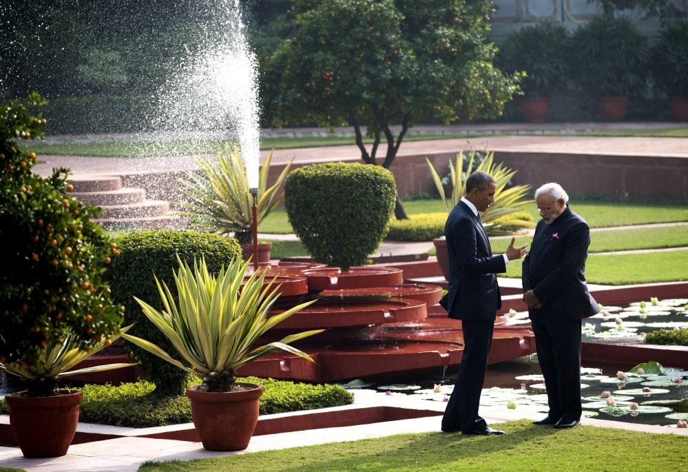 Indian Prime Minister Narendra Modi and US President Barack Obama talk in the gardens between meetings at Hyderabad House in New Delhi on Jan. 25, 2015. (Photo by Saul Loeb/AFP/Getty)