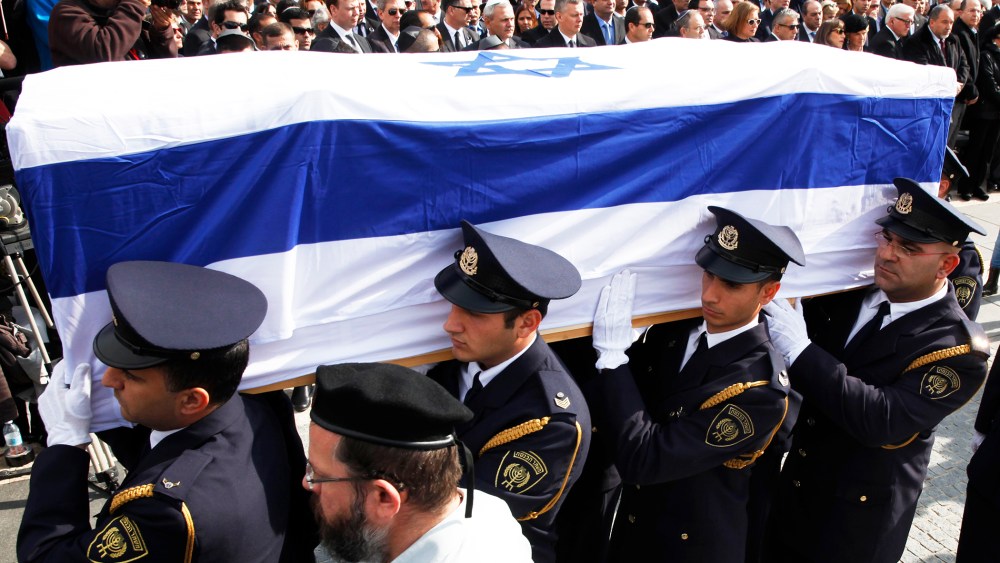 An honor guard carries the coffin of former Israeli prime minister Ariel Sharon, Jan. 13, 2014.