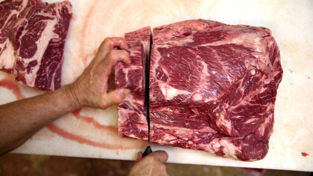 A butcher prepares cuts of beef at on January 13, 2014 in North Miami Beach, Florida.