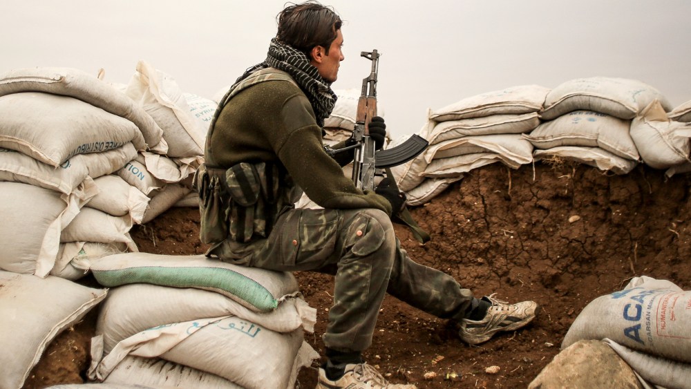 A Free Syrian Army fighter in the City of Hrjala in the countryside near Aleppo prepares to fight against ISIS on Dec. 10, 2014.