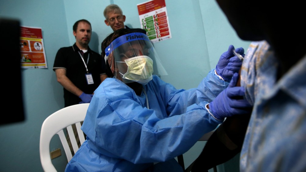 A nurse administers an injection to Emmanuel Lansana, 43, the first person to take part in the Ebola vaccine trials being conducted at Redemption Hospital, formerly an Ebola holding center, on Feb. 2, 2015 in Monrovia, Liberia. (Photo by John Moore/Getty)