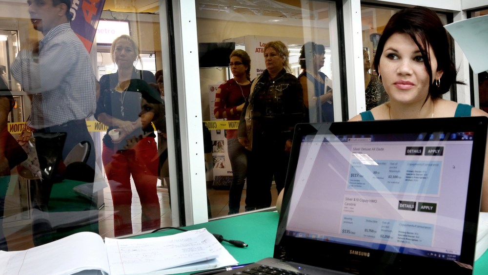 People stand in line to speak with an insurance agent to purchase health insurance under the Affordable Care Act at the Mall of Americas on Jan. 15, 2014 in Miami, Florida.