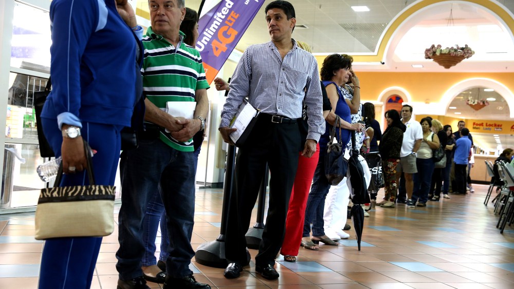 People waiting to speak with an insurance agent as they try to purchase health insurance under the Affordable Care Act at the kiosk setup at the Mall of Americas on Jan. 15, 2014 in Miami, Florida.