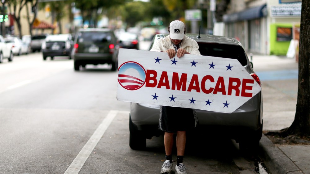 Pedro Rojas holds a sign directing people to an insurance company where they can sign up for the Affordable Care Act, also known as Obamacare, before the February 15th deadline on Feb. 5, 2015 in Miami, Fla. (Photo by Joe Raedle/Getty)