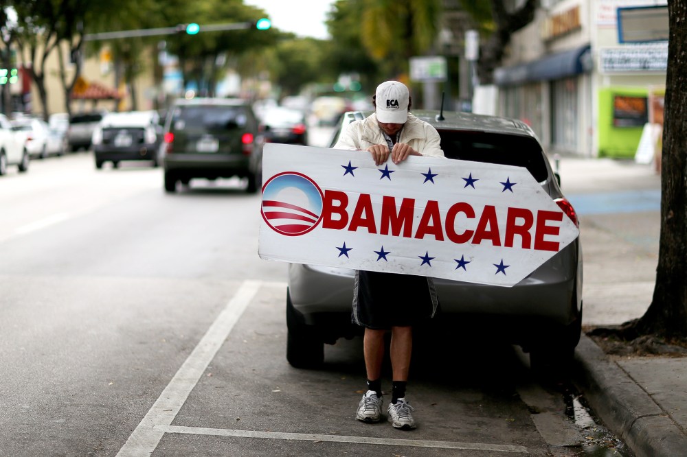 Pedro Rojas holds a sign directing people to an insurance company where they can sign up for the Affordable Care Act, also known as Obamacare, before the February 15th deadline on Feb. 5, 2015 in Miami, Fla. (Photo by Joe Raedle/Getty)