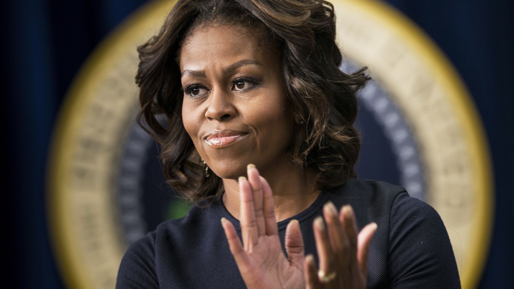 US first lady Michelle Obama applauds during an event at the White House, Jan. 16, 2014.