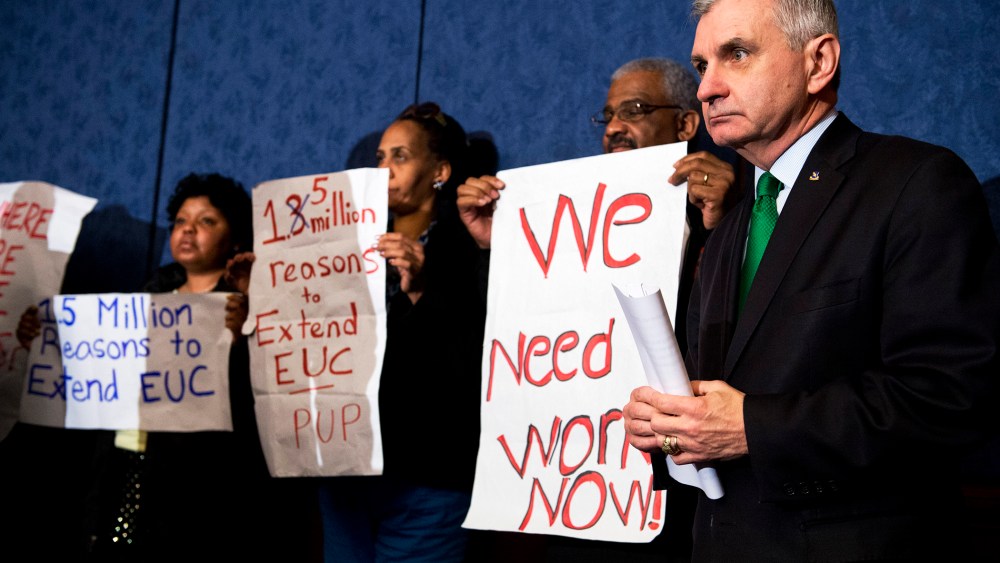 Sen. Jack Reed stands with unemployed Americans during a news conference in the Capitol Visitor Center to urge Congress to extend unemployment benefits, Jan. 16, 2014.