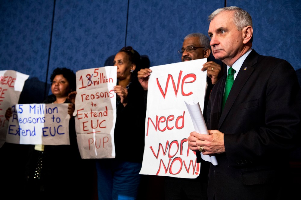 Sen. Jack Reed stands with unemployed Americans during a news conference in the Capitol Visitor Center to urge Congress to extend unemployment benefits, Jan. 16, 2014.