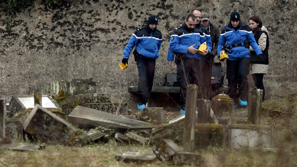 French Gendarmes investigate near defaced tombstones at the Jewish cemetery of Sarre-Union, northeastern France on Feb. 16, 2015. (Photo by Frederick Florin/AFP/Getty)