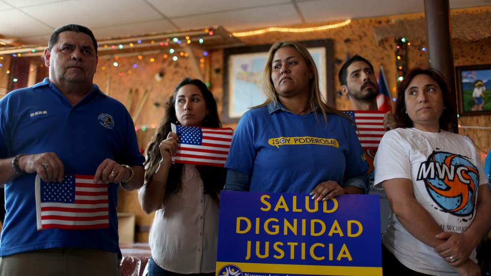 People stand together as they hold a press conference to protest the district court judge in Brownsville, Texas, who issued a preliminary injunction that temporarily blocks the implementation process of President Barack Obama's Executive Action.