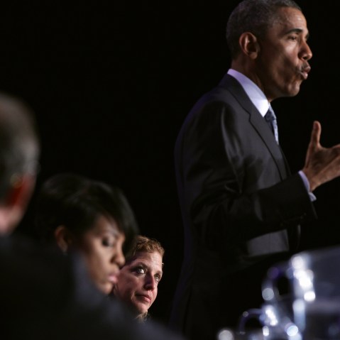 President Barack Obama speaks as Democratic National Committee Chair and Rep. Debbie Wasserman Schultz (D-FL) looks on during the General Session of the 2015 DNC Winter Meeting, Feb. 20, 2015 in Washington, DC. (Photo by Alex Wong/Getty)
