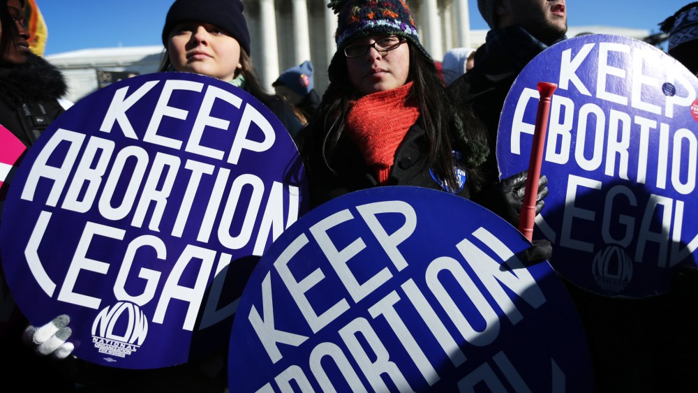 Pro-choice activists hold signs in front of the U.S. Supreme Court January 22, 2014.