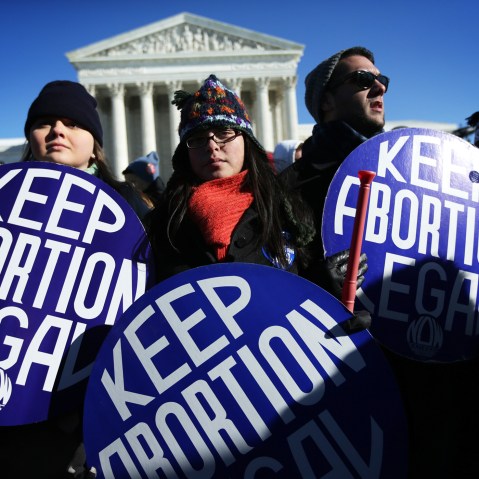 Pro-choice activists hold signs in front of the U.S. Supreme Court on Jan. 22, 2014 on Capitol Hill in Washington, D.C. (Photo by Alex Wong/Getty)