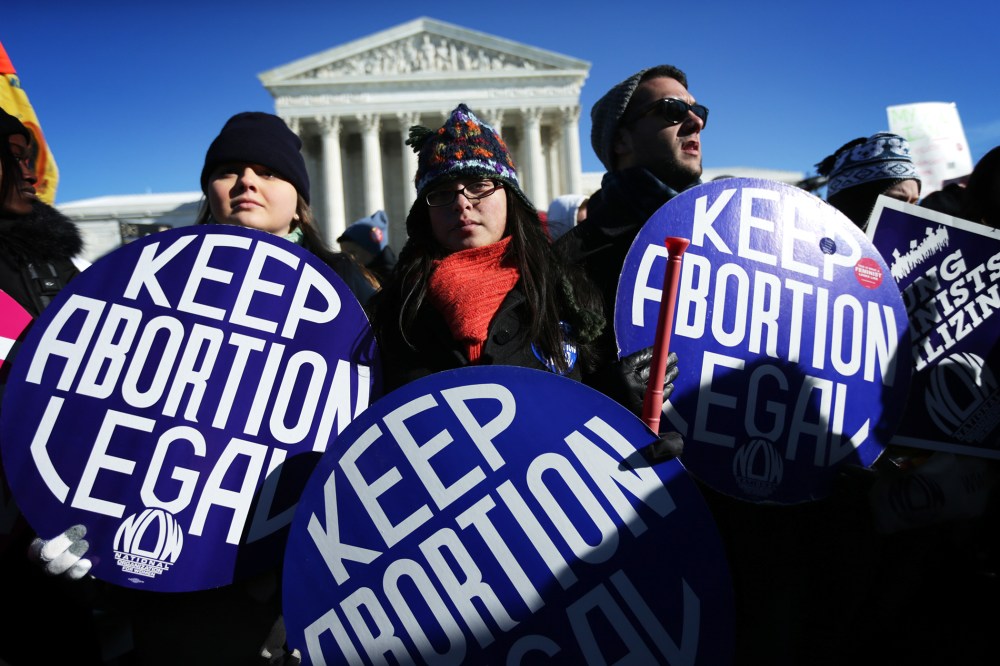 Pro-choice activists hold signs in front of the U.S. Supreme Court on Jan. 22, 2014 on Capitol Hill in Washington, D.C. (Photo by Alex Wong/Getty)