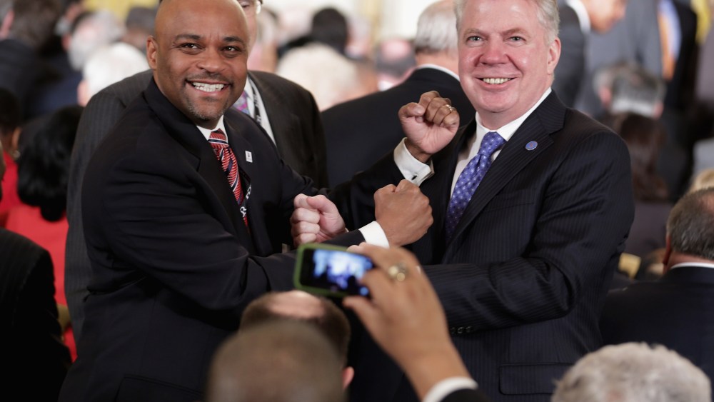Denver Mayor Michael Hancock (L) and Seattle Mayor Ed Murray posing for photographs during a reception in the East Room of the White House Jan. 23, 2014 in Washington, DC.