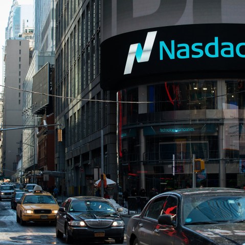 Cars drive past the NASDAQ MarketSite on March 2, 2015 in New York City.