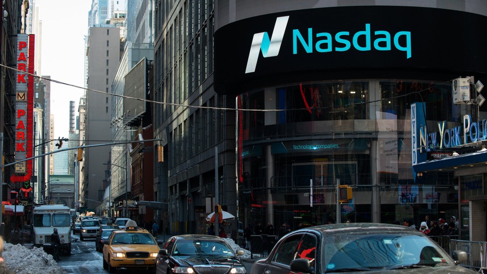 Cars drive past the NASDAQ MarketSite on March 2, 2015 in New York City.