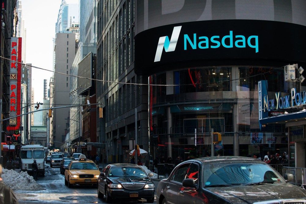 Cars drive past the NASDAQ MarketSite on March 2, 2015 in New York City.