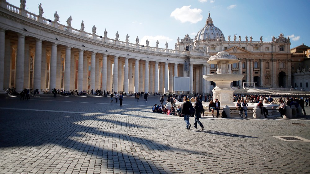 Visitors and tourists walk near the Basilica in St Peter's Square in Vatican City on Feb. 17, 2015. (Photo by Alessia Pierdomenico/Bloomberg/Getty)