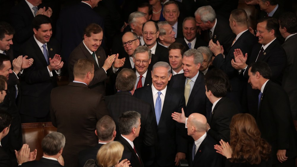 Israeli Prime Minister Benjamin Netanyahu is greeted by members of Congress as he arrives to speak during a joint meeting of the United States Congress at the Capitol March 3, 2015 in Washington, DC. (Photo by Chip Somodevilla/Getty)