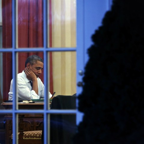 President Obama Works In The Oval Office At The White House
