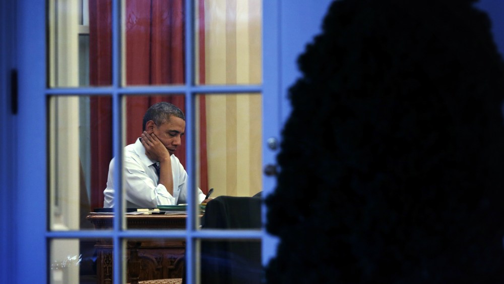 President Obama Works In The Oval Office At The White House