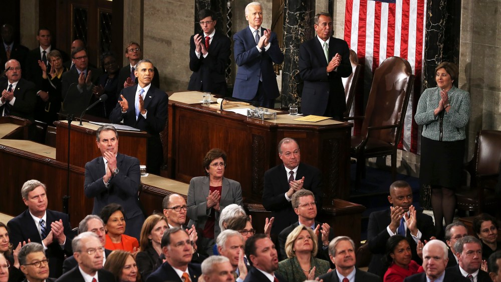 U.S. President Barack Obama and others applaud during the State of the Union, Jan. 28, 2014.