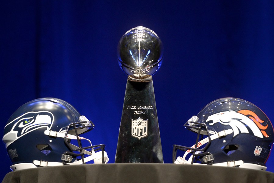 The Vince Lombardi Trophy and helmets for the Denver Broncos and the Seattle Seahawks are displayed, Jan. 31. 2014.