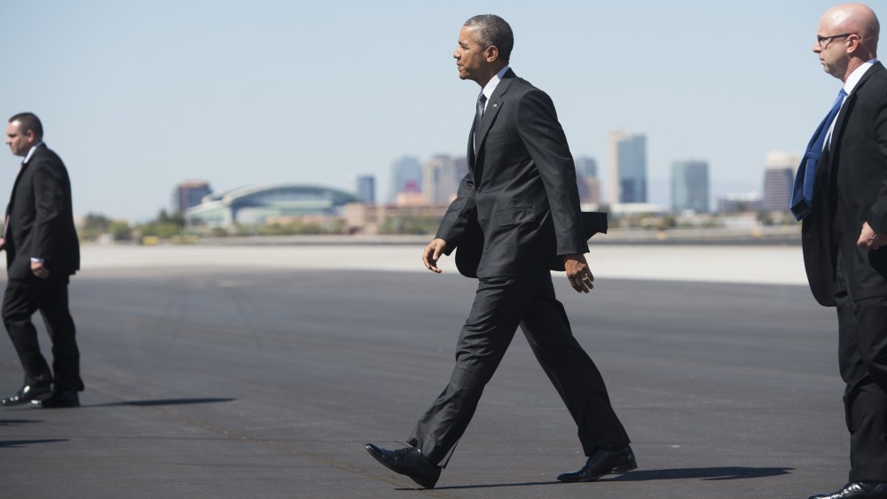 US President Barack Obama walks across the tarmac upon arrival on Air Force One at Phoenix Sky Harbor International Airport in Phoenix, Ariz., March 13, 2015. (Photo by Saul Loeb/AFP/Getty)