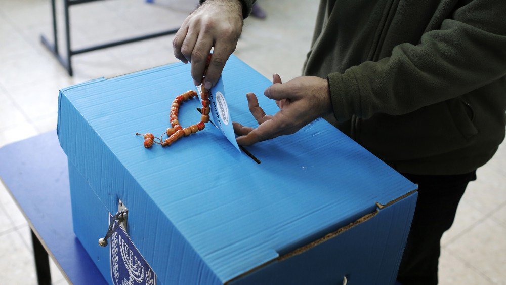 An Arab Israeli man casts his ballot at a polling station in the northern Israeli town of Umm al-Fahm on March 17, 2015. (Photo by Ahmad Gharabli/AFP/Getty)