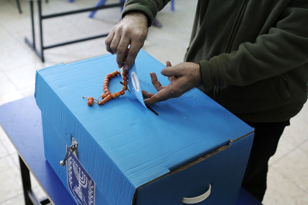 An Arab Israeli man casts his ballot at a polling station in the northern Israeli town of Umm al-Fahm on March 17, 2015. (Photo by Ahmad Gharabli/AFP/Getty)
