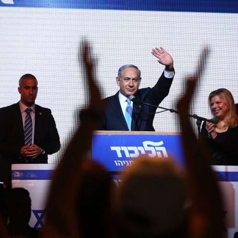 Israeli Prime Minister Benjamin Netanyahu (C) delivers a speech next to his wife Sara as he reacts to exit poll figures in Israel's parliamentary elections late on March 17, 2015 in Tel Aviv, Israel. (Photo by Menahem Kahana/AFP/Getty)