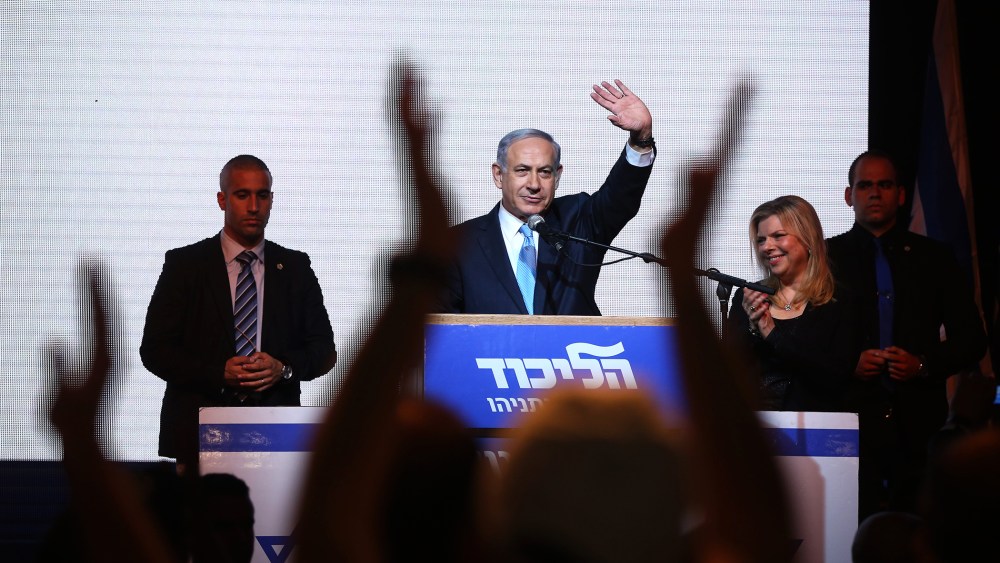 Israeli Prime Minister Benjamin Netanyahu (C) delivers a speech next to his wife Sara as he reacts to exit poll figures in Israel's parliamentary elections late on March 17, 2015 in Tel Aviv, Israel. (Photo by Menahem Kahana/AFP/Getty)