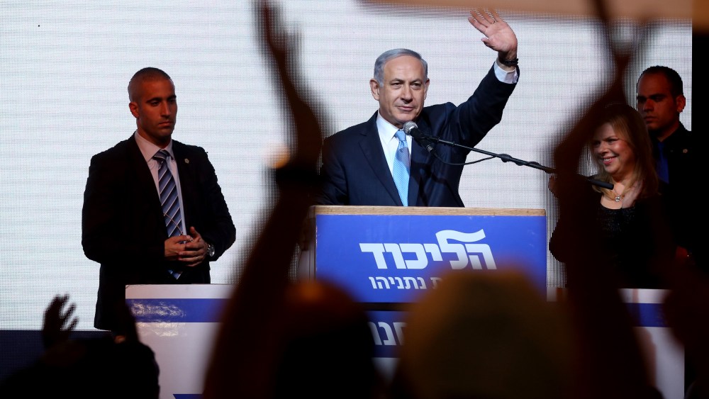 Israeli Prime Minister Benjamin Netanyahu delivers a speech next to his wife Sara as he reacts to exit poll figures in Israel's parliamentary elections late on March 17, 2015 in the city of Tel Aviv. (Photo by Menahem Kahana/AFP/Getty)
