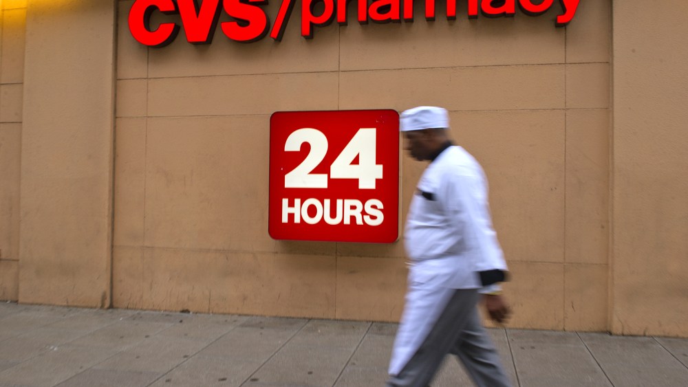 A man passes a CVS drugstore in Washington, DC, Feb. 5, 2014.