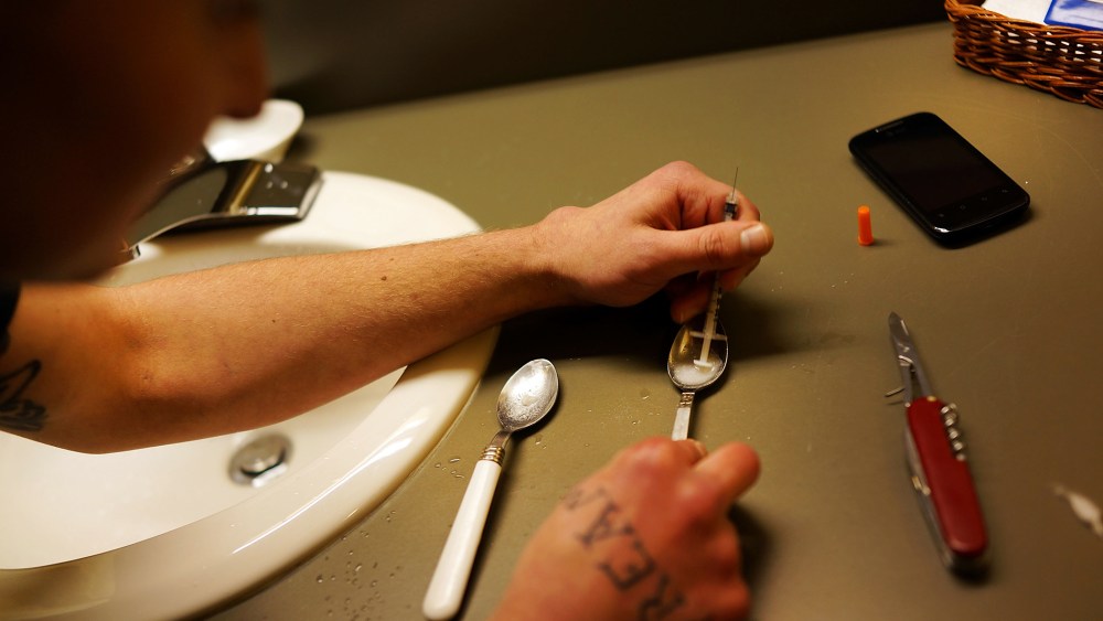 Drugs are prepared to shoot intravenously by a user addicted to heroin in Vermont, Feb. 6, 2014.