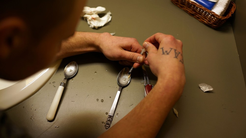 Drugs are prepared to shoot intravenously by a user addicted to heroin, February 6, 2014.